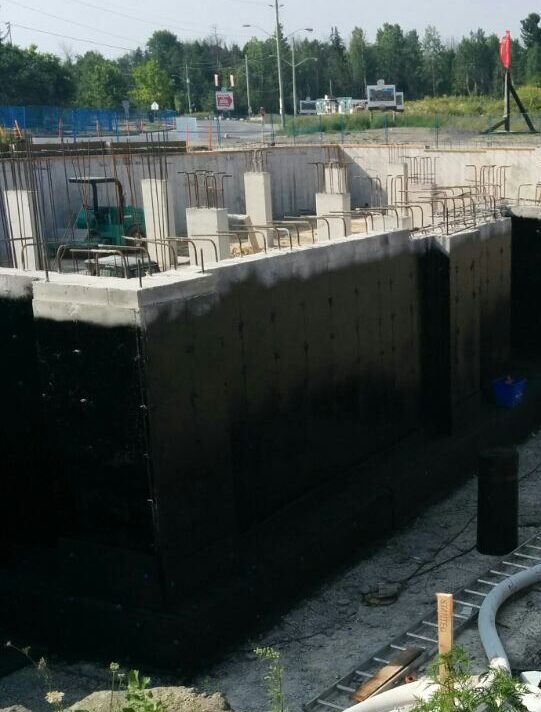 Spray-applied dampproofing on a large foundation
