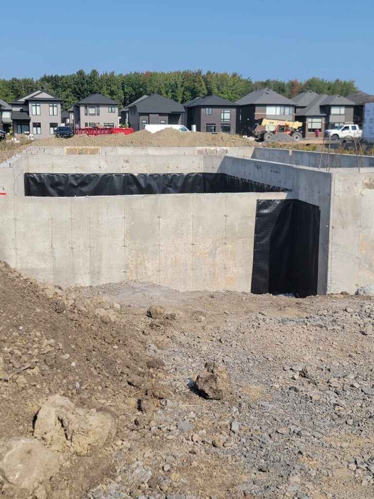 Waterproofing transition between membrane systems at a foundation corner